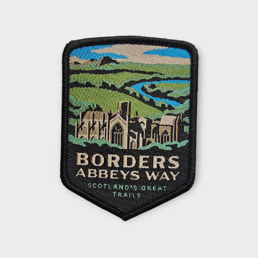 Embroidered patch of Borders Abbeys Way with scenic design on a white background