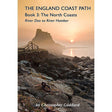 Book cover for 'The England Coast Path: Book 3: The North Coasts - River Dee to River Humber' by Christopher Göddard, featuring a coastal landscape with a rocky shore, a stone wall, and a castle under a warm sunset sky.