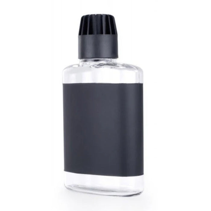 Clear hip flask with black cap on a white background