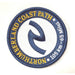 A circular embroidered patch for the Northumberland Coast Path, featuring a navy blue border and central symbol on a white background with yellow and white text.