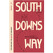 Book cover for 'South Downs Way' guidebook by Sparky, featuring a dusty red background with large cream-colored text and minimalist black line drawings of a hiker, butterfly, and landscape.