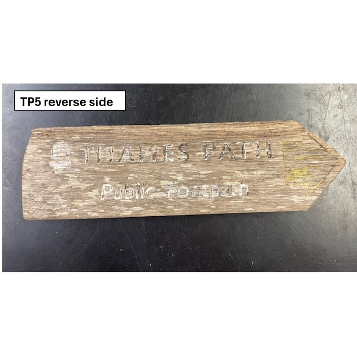Wooden sign with 'Thames Path Public Footpath' text on a dark background