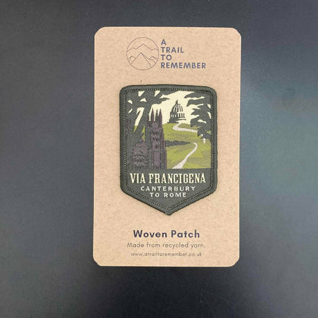 Woven patch on a cardboard backing with 'Via Francigena' design and branding.