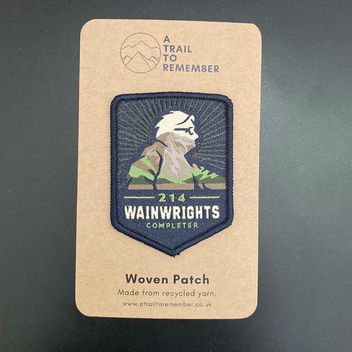 Woven Wainwrights Completer patch on a cardboard card with 'A Trail to Remember' branding
