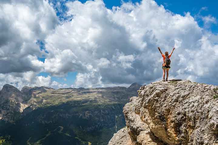 Woman celebrating on top of mountain